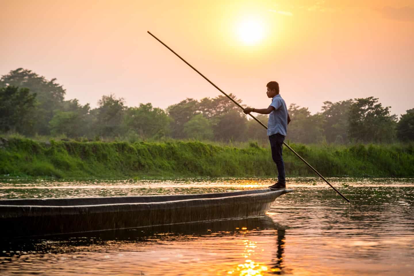Man on boat in jungle Nepal