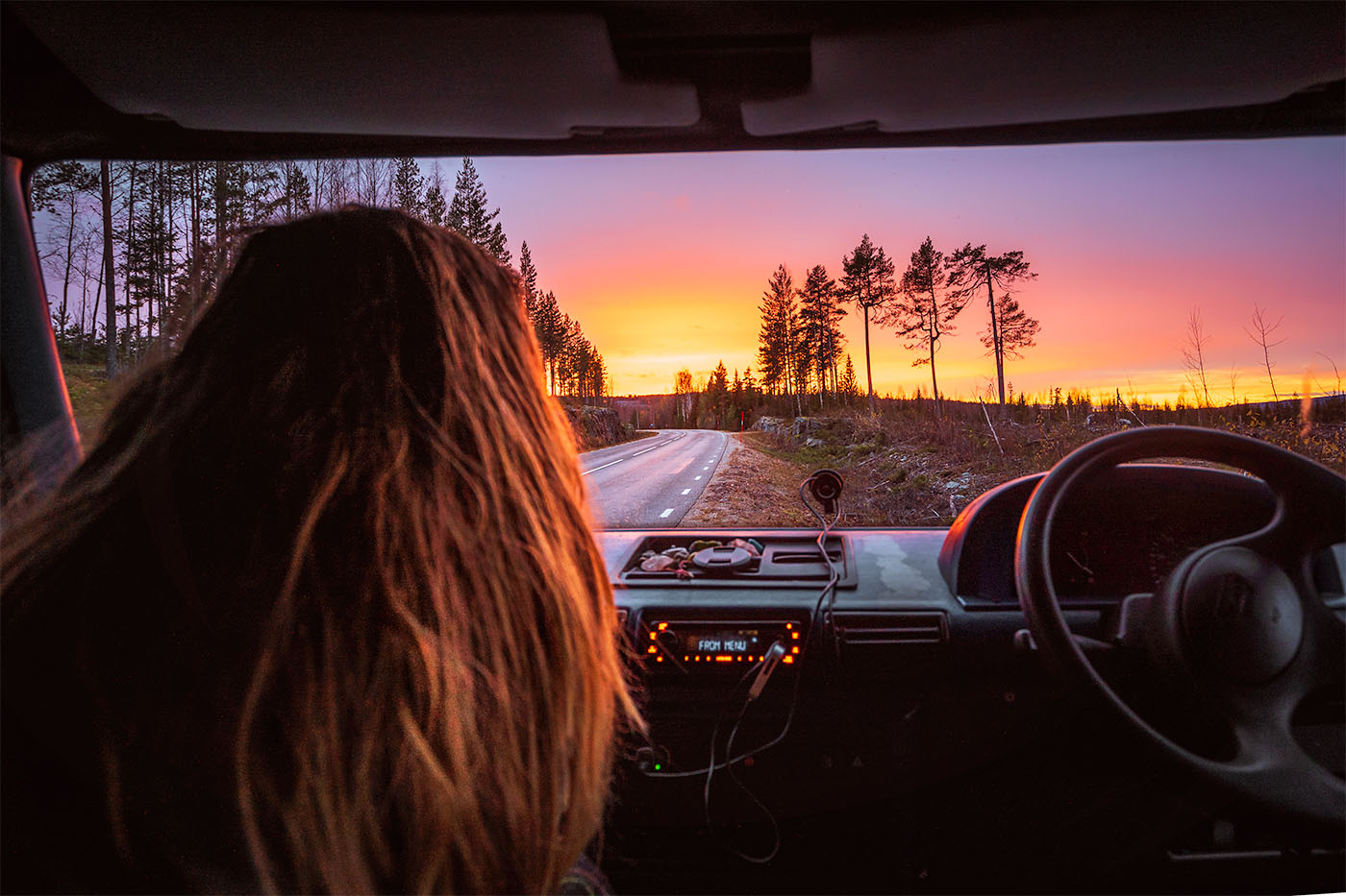 view through campervan windscreen at colourful sunset
