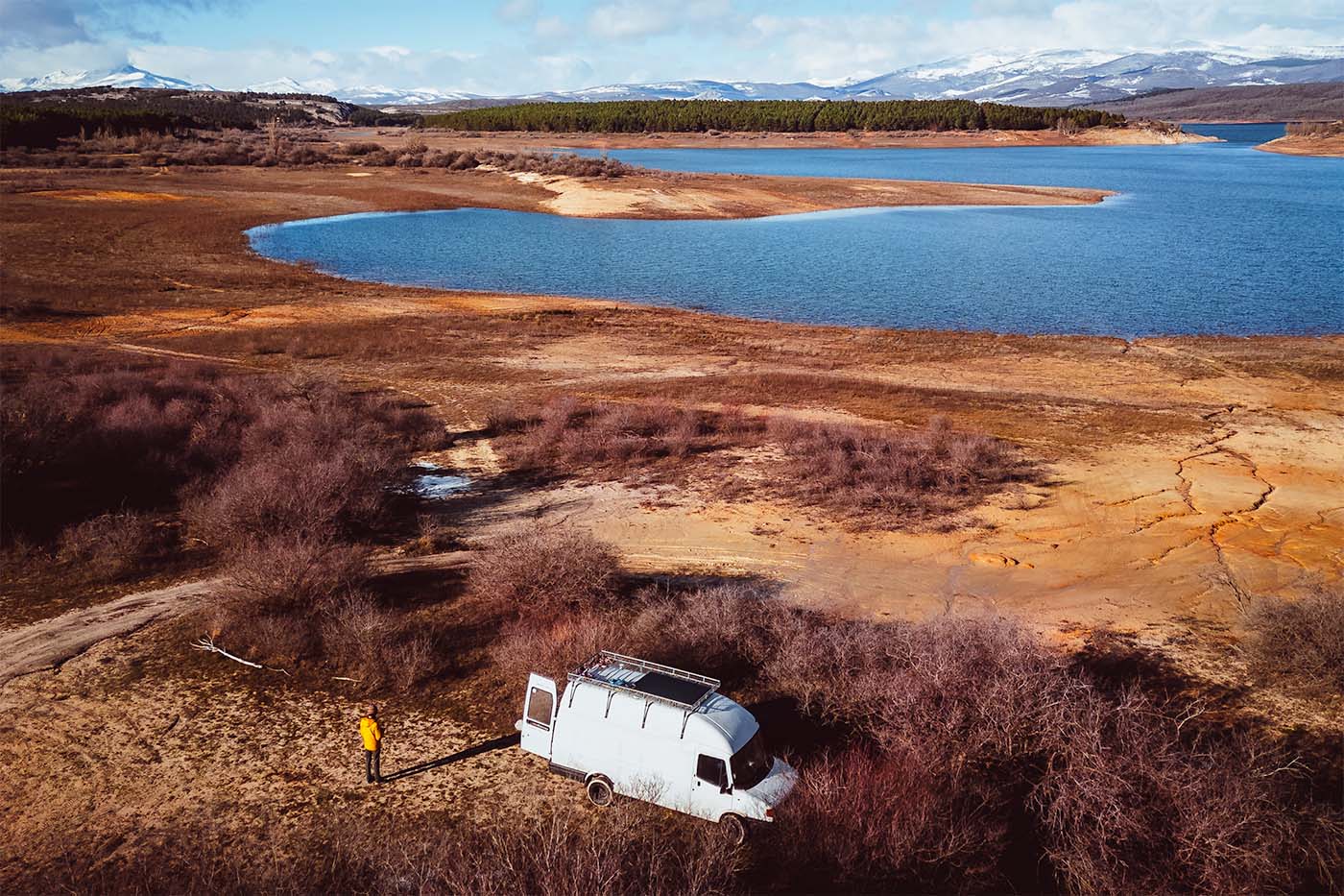 view of campervan, lake and mountains