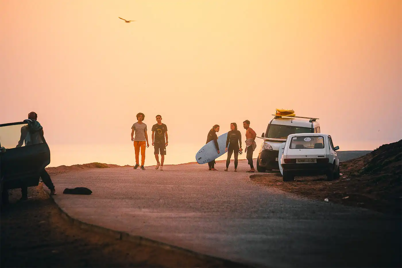 Surfers at sunset in Tamraght