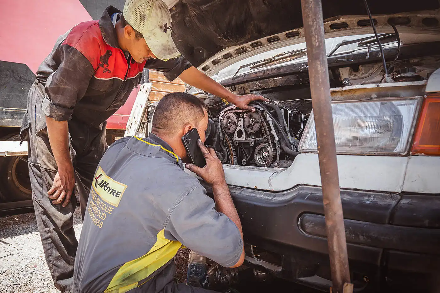 mechanics checking timing chain of van 